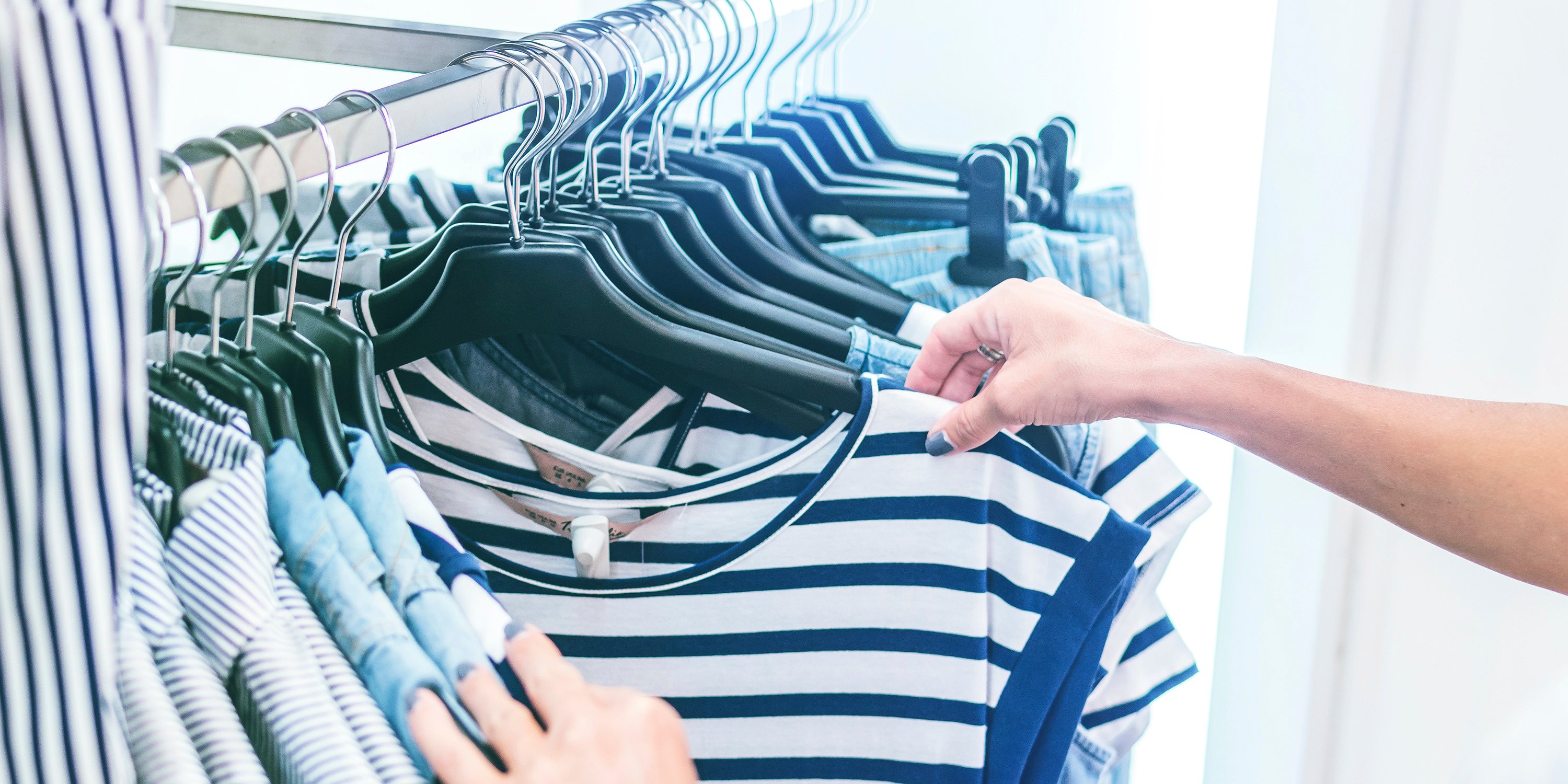 Close of female looking at clothes on rack