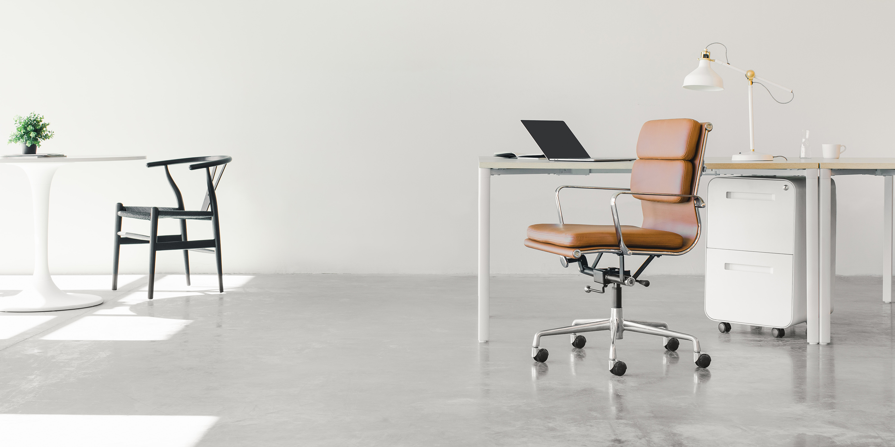 Swivel chair and basic office furniture in light minimal office space